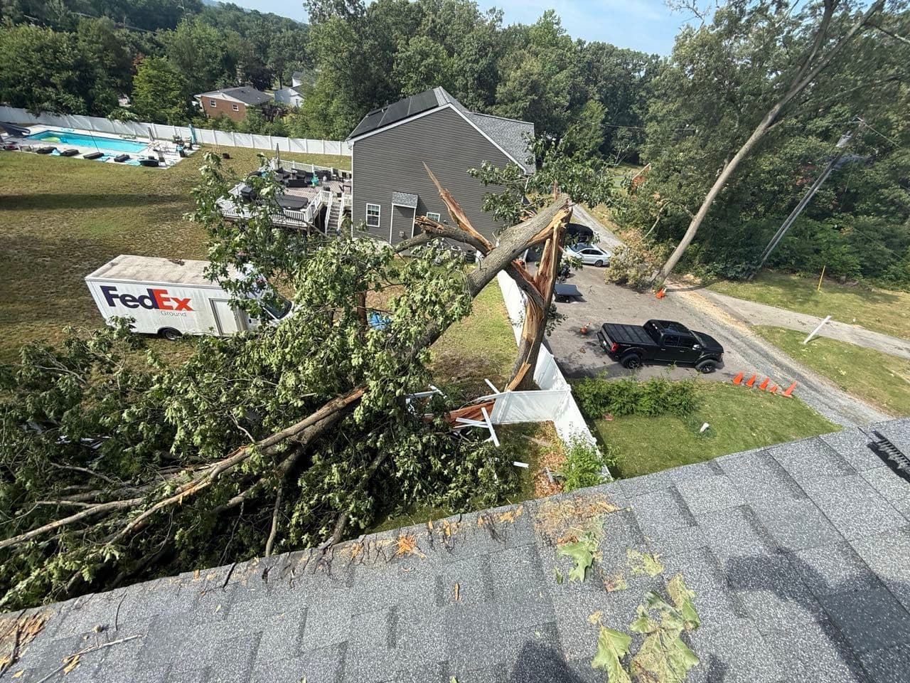 Aerial view from the roof of a large tree fallen across a Severn, Maryland property after a July storm